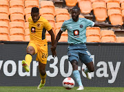 Phathutshedzo Nange of Kaizer Chiefs challenges Deon Hotto of Orlando Pirates in the DStv Premiership Soweto derby at FNB Stadium on November 6 2021.