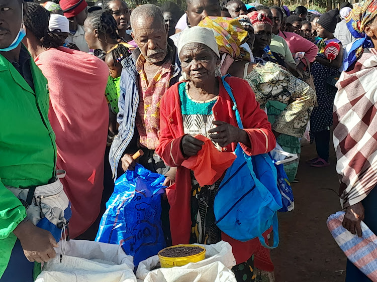 Milima-ini residents in Juja, Kiambu County wait for relief food on Friday