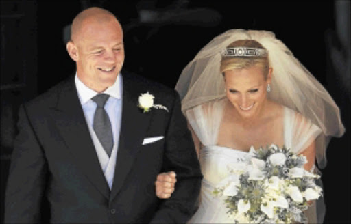 Former England rugby captain Mike Tindall and Zara Phillips, the eldest granddaughter of Queen Elizabeth, leave Canongate Kirk in Edinburgh, Scotland, after getting married