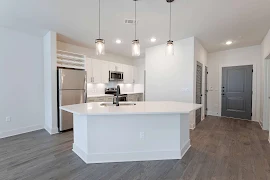 Kitchen with middle island featuring pendant lighting