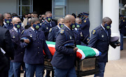 Lt-Col Charl Kinnear's colleagues carry his coffin to a hearse after his funeral in Cape Town on October 3 2020.