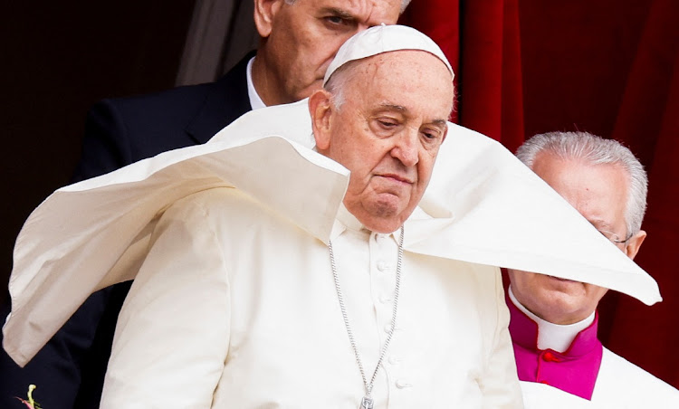 Pope Francis looks on from a balcony at St. Peter's Square, on Easter Sunday, at the Vatican March 31, 2024.