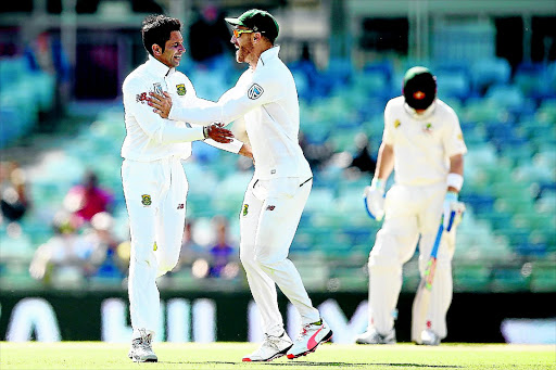 Keshav Maharaj and Faf du Plessis celebrate after defeating Australia in the first test at the Waca. Photo: Paul Kane/Getty Images