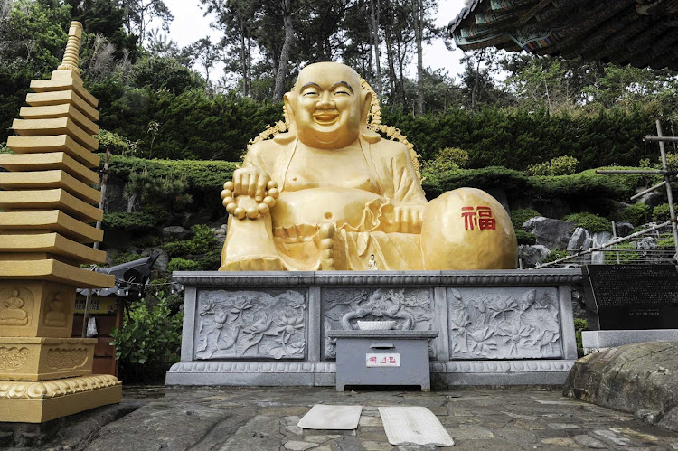 A laughing Buddha at the Haedong Yonggungsa Temple in Busan, South Korea.