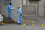 Police at the scene outside Maseti Incorporated where an East London lawyer was shot and wounded in Vincent on Friday morning.