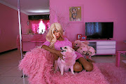 Ennie Tembie Cleary, aka  Barbie Brazil, poses in pink with her pink dogs in her pink Johannesburg home. She believes there cannot be too much pink in a woman's life - and her husband and son have to agree. 