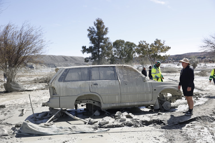 Charlesville residents inspect the damage caused on private property following a tailings dam collapsed.