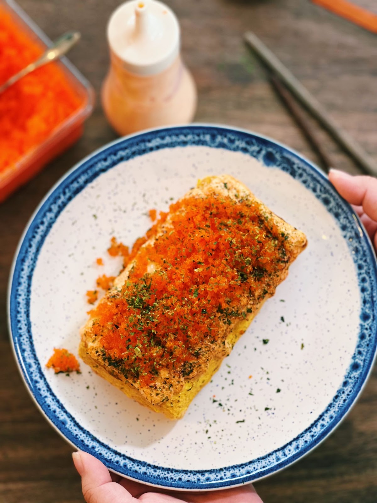 Tamagoyaki, a Japanese Omelette, rolled and sliced, topped with creamy Masago mayo, capturing the essence of a classic Japanese dish.