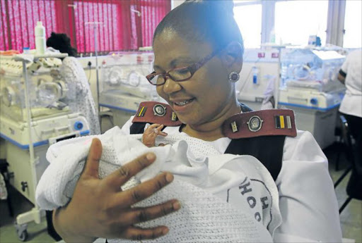 HOPE FOR BLESSING:Yoliswa Mnyanda with baby Blessing who was found in a black plastic bag in Gonubie last week. He survived the traumatic ordeal and was named Blessing by staff at Frere Hospital. Offers have been pouring in on social media to help the baby and an account has been opened for funds to support him Picture: MICHAEL PINYANA