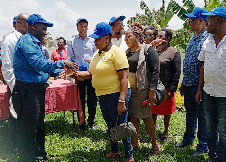 The region’s chair Alfred Wanyoike receiving defectors from other political parties into the Azimio movement