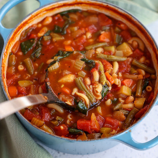 A thick and tasty Italian Minestrone Soup loaded with onion, celery, carrots, tomatoes, zucchini, green beans, elbow noodles, and white beans in a perfectly seasoned tomato base.