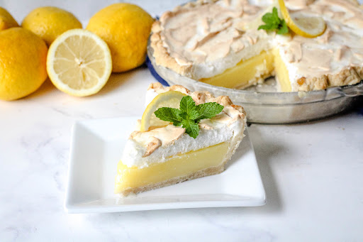 A slice of Lemon Meringue Pie on a plate.