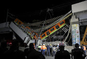 The site where an overpass for a metro partially collapsed with train cars on it is seen at Olivos station in Mexico City, Mexico, on May 4 2021. 