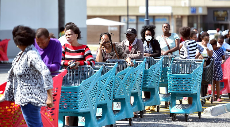 A pensioner slumps over her trolley waiting for the queue to move at Greenacres shopping centre on March 31