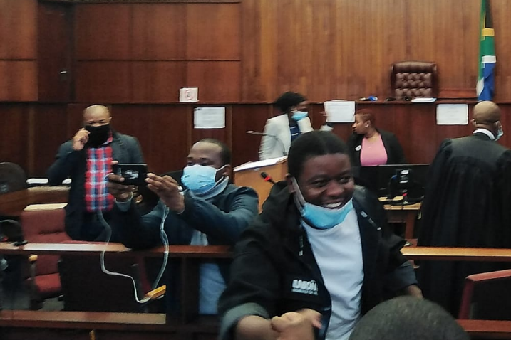 Fees Must Fall activist Bonginkosi Khanyile laughs and greets friends and family in the Durban magistrate's court on Tuesday, where the state painted him as a deadbeat dad.