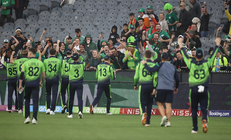 Irish players celebrate with their fans after defeating England at the ICC T20 World Cup at Melbourne Cricket Ground on October 26 2022.