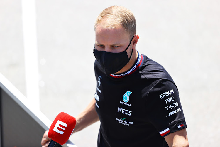 Valtteri Bottas talks to journalists in the paddock during previews ahead of the F1 Grand Prix of Spain at Circuit de Barcelona-Catalunya on May 6 2021 in Barcelona, Spain.