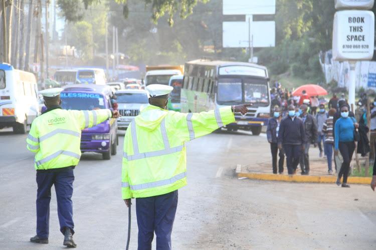 Police officers controllig traffic along Ngong Road as NMS conducted a second test run at the Green Park terminal May 28.