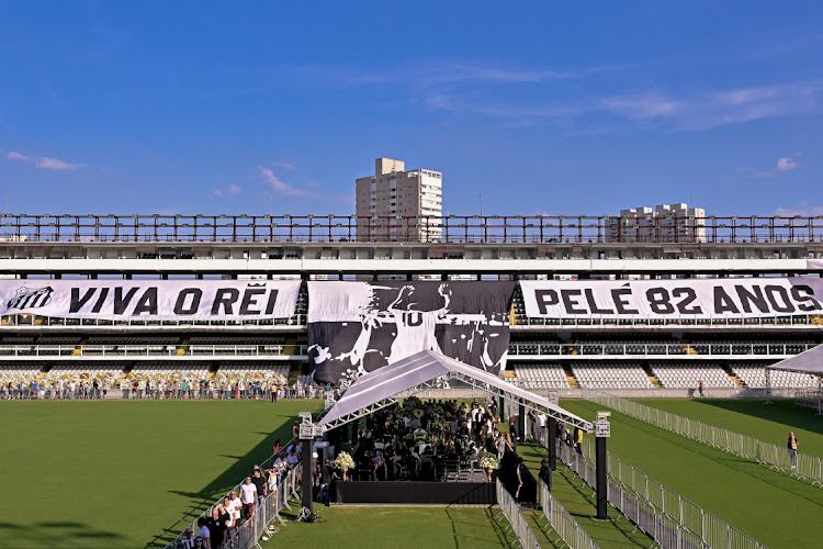 Flags remembering Pelé are displayed on the stands as mourners queue inside Vila Belmiro stadium to pay their respects to late football legend Pelé during his funeral in Santos, Brazil on January 2 2023. Brazilian football icon Edson Arantes do Nascimento, better known as Pele, died on December 29 2022 aged 82 after a battle with cancer in Sao Paulo, Brazil.