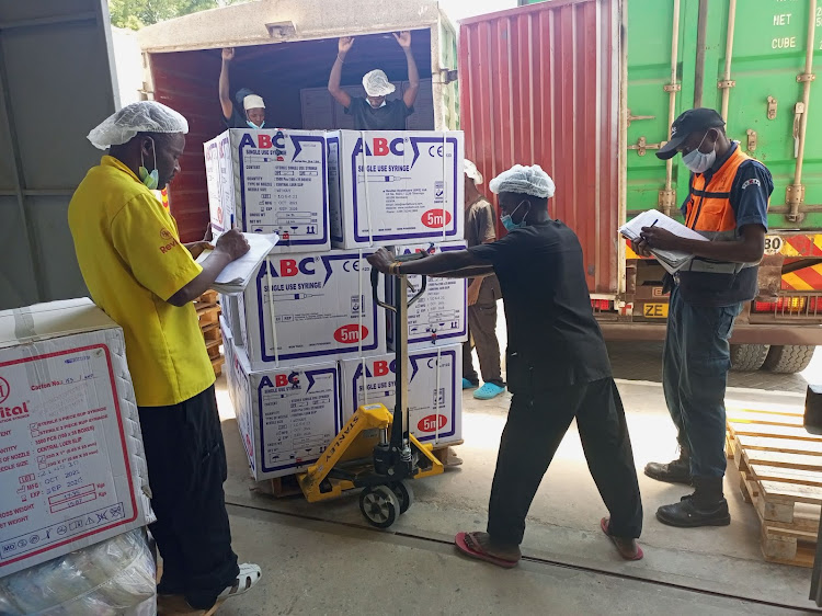 Workers load a consignment destined for Kemsa at the Revital Healthcare (EPZ) Ltd warehouse in Kikambala, Kilifi county on Saturday.