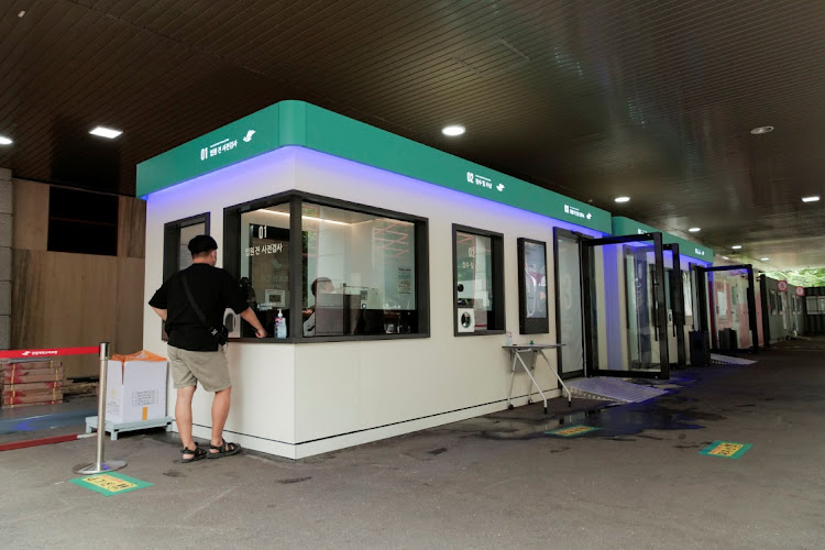 A patient stands in front of a smart booth, which allows contactless medical check-up, at Hallym University Medical Center (HUMC) in Anyang, South Korea August 12 2021. Picture: REUTERS/DAEWOUNG KIM