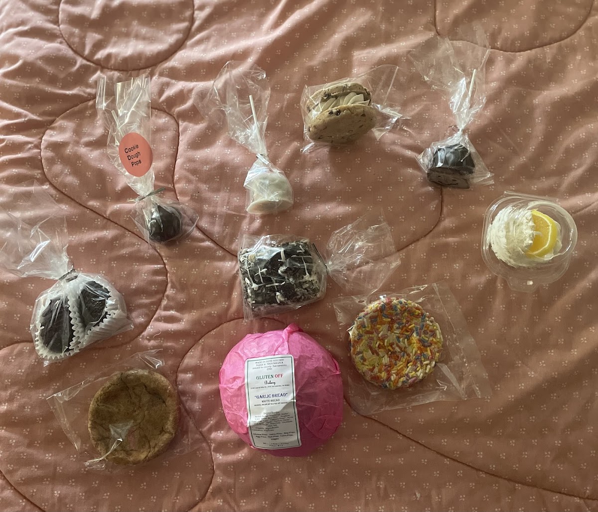 Chocolate peanut butter eggs, chocolate cakepop, chocolate chip cookie dough pop, Oreo rice crispy, treat, lemon, cupcake, chocolate chip cookie sandwich, confetti, cookie, snickerdoodle, cookie, red velvet cakepop, garlic sourdough loaf