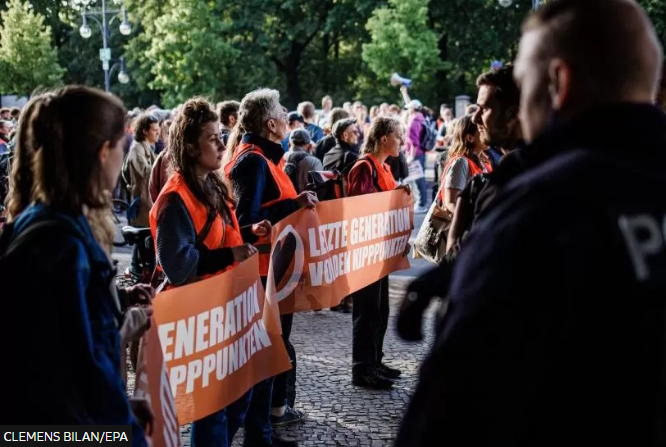 German police raid climate activists who blocked traffic - BBC News