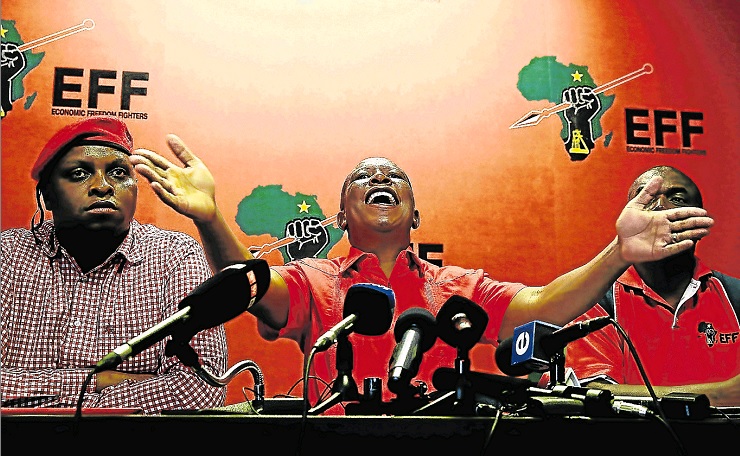 EFF leader Julius Malema, with his deputy Floyd Shivambu, left, and Godrich Gardee, address the press earlier this year.