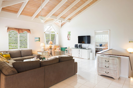 Bright living room with spacious corner sofa in this luxury house for sale in Cooper Jack Bay Settlement ($1,799,000)