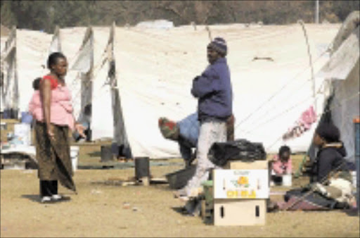 UNSETTLED FUTURE: Foreign nationals at a temporary shelter near the Rand Airport in Germiston. The shelter is one of six which will be dismantled next Friday. Pic. Peter Mogaki. 04/08/08. © Sowetan.