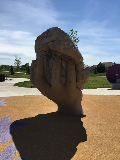 Hand Holding Boulder