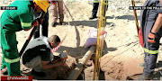 Rescuers at the entrance to a shaft at Nuttaboy mine in the Northern Cape. Several tunnels and shafts, which artisanal diamond miners had dug, collapsed last Wednesday trapping an estimated 12 miners underground