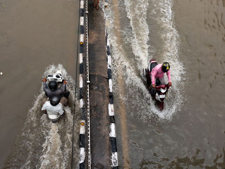 Motorists ride through the flooded roads in New Delhi, India, on Friday, July 14 2023. The Yamuna River has spilled onto roads surrounding Delhi’s historic Red Fort. Picture: BLOOMBERG