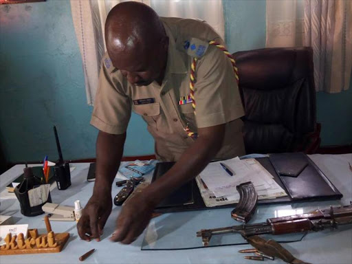 Bungoma OCPD david Kirui displaying a riffle recovered from the suspect.PHOTS JOHN NALIANYA