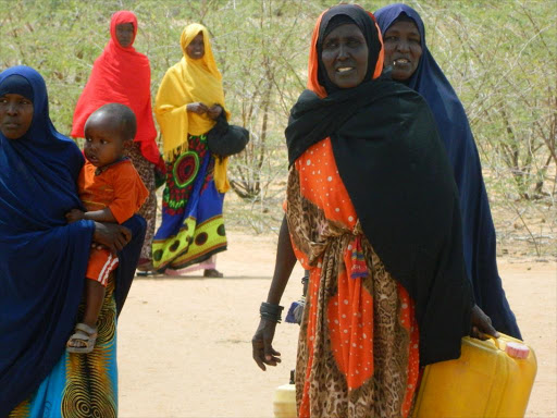 women from Banane in Lagdera constituency going to fetch water at a water pan on saturday .it is 10 KMs from their home steads.