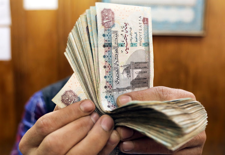 An employee counts Egyptian pounds at a foreign exchange office in central Cairo, Egypt, March 20 2019. Picture: MOHAMED ABD EL GHANY/REUTERS