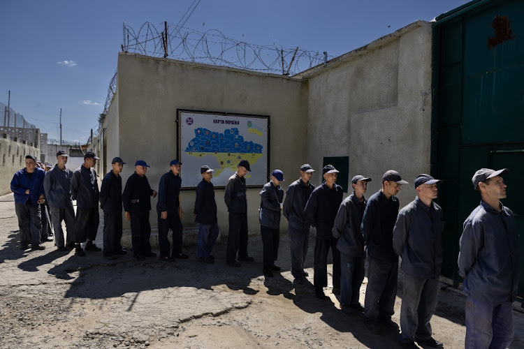 Prisoners line up for lunch outside the Russian prisoner of war detention camp in the Lviv region, western Ukraine on August 3, 2023. Hundreds of captured Russian POW include conscripts, mercenaries, Wagner militia and Storm-Z Russian prisoners, held in one of 50 sites around Ukraine. Storm-Z is a series of penal military units established by Russia since April 2023.