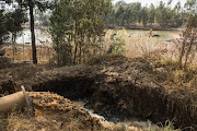 Partially treated acid mine water is pumped into a settling dam at the head waters of the Tweelopiespruit