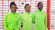 Winner of the Spar 10km Grand Prix race Tadu Nare (middle) of Ethiopia poses with second place finisher Helalia Johannes (right) of Namibia and third-placed Selam Gabre of Ethiopia.