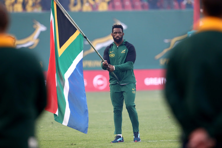 Siya Kolisi holds the South African flag ahead of the Springboks' game against Argentina at Ellis Park last month.