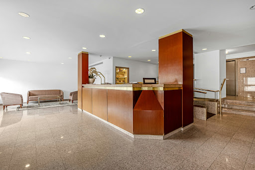 Reception area with wooden desk and armchairs - Luxury house for sale in Fort Lee