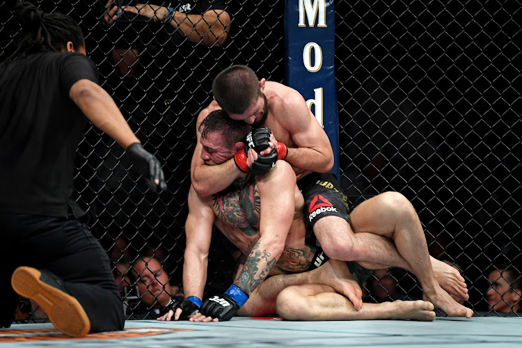 Khabib Nurmagomedov (red gloves) fights Conor McGregor (blue gloves) during UFC 229 at T-Mobile Arena in Las Vegas on October 6 2018.