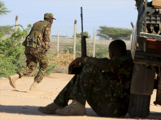 A Kenya Defence Forces soldier runs for cover near the perimeter wall of Garissa University College following an attack on April 2, 2015. Photo/REUTERS