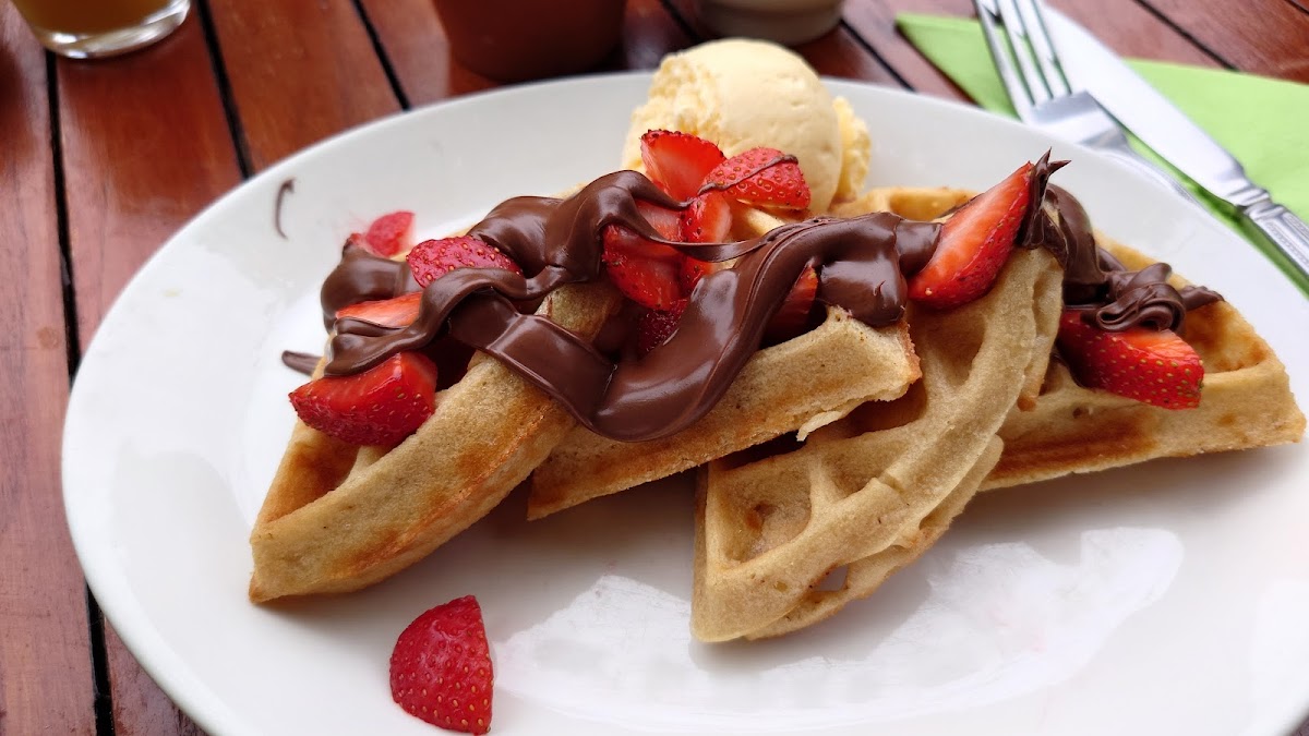 gluten free waffle with nutella, strawberries and vanilla ice cream