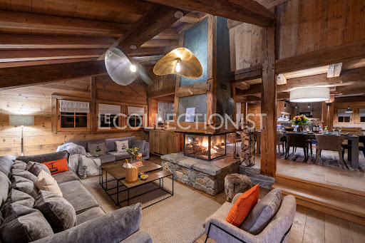 Living room with fireplace and modern furniture in this luxury house for seasonal rental in Megeve ($18,001 - 280 m²)