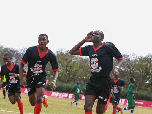 Fred Kendigi celebrates one of his two goals scored during the COPA Coca-Cola Africa Cup opening match.