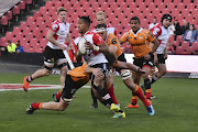 Sylvian Mahuza of the Xerox Golden Lions gets away from a tackle during the Currie Cup match against the Toyota Free State Cheetahs at Emirates Airline Park on September 08, 2018 in Johannesburg.