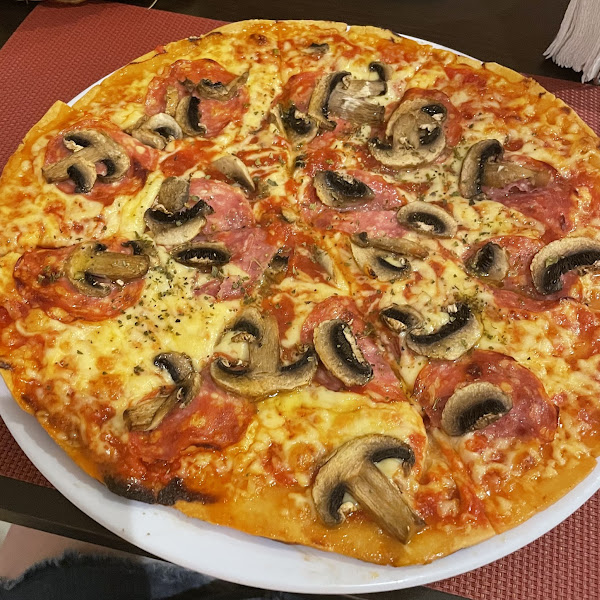 Gluten free pizza with salami and mushroom