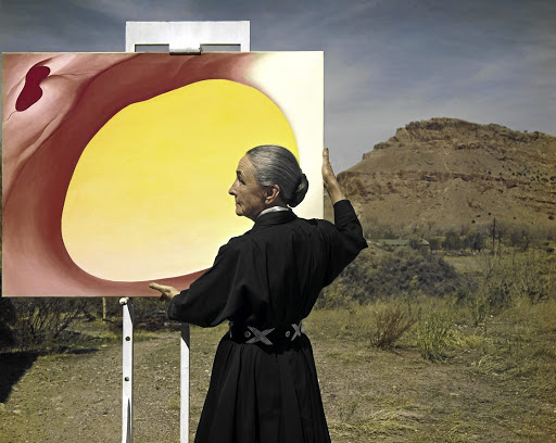 American painter Georgia O'Keeffe outside her art studio in Abiquiu, New Mexico, in 1960, with a painting from her 'Pelvis' series.