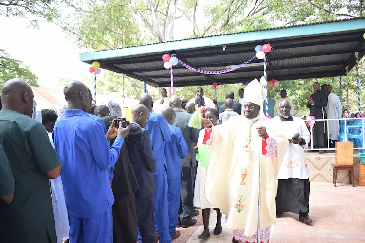 Bungoma Catholic Diocese Bishop Mark Kadima blesses the couples ahead of the mass wedding